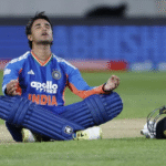 Abhishek Sharma raises his bat to celebrate a 35-ball century during the 3rd T20I against New Zealand in Wellington.