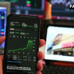 Trader’s hands on keyboard as easing oil prices boost Sensex and Nifty