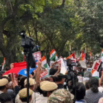 Demonstrators hold signs against SIR near Bangla Sahib in Delhi.