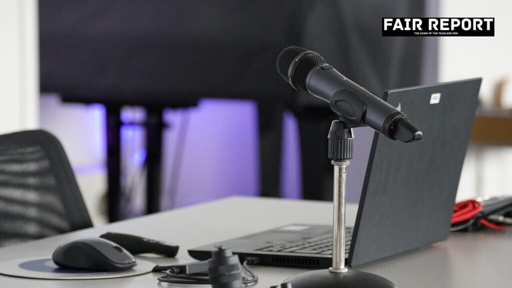 Professional television camera on tripod in briefing room representing a multimedia news agency
