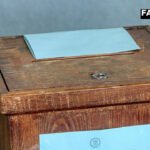 A close-up view of a metal ballot box representing the debate over a return to ballot papers in elections.