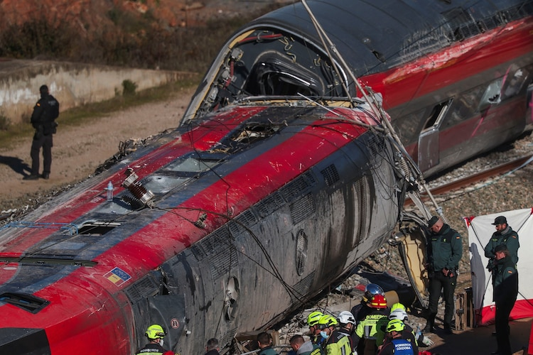 Emergency responders and rescue crews work around the damaged carriages of a high-speed train collision near Urda in Toledo province, Spain.