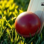 Cricket bat and red leather ball on a grass pitch representing the aggressive batting approach of Vaibhav Suryavanshi